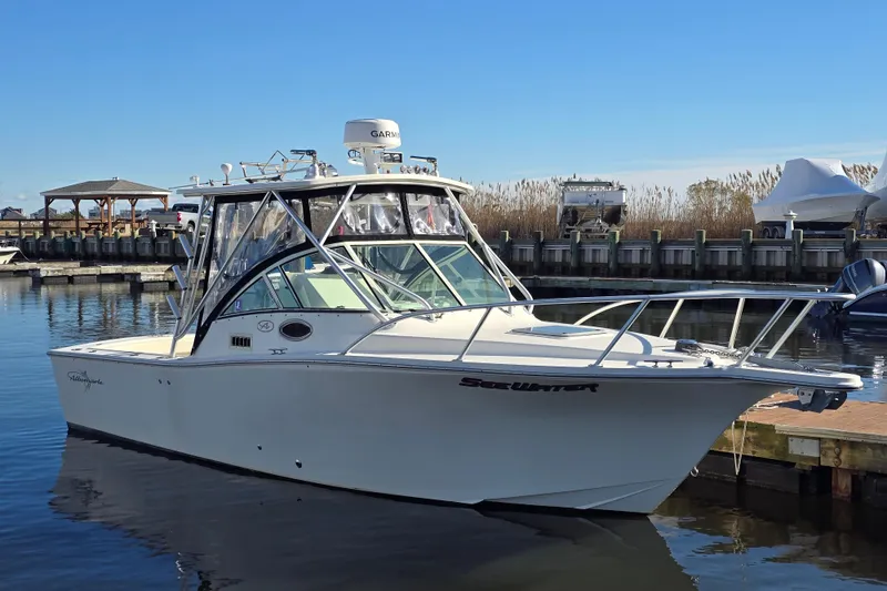 The Image of 2006 Albemarle 268 Express Fisherman boat docked in a marina under clear blue skies. - 0