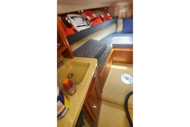 Slide: The Image of 2006 Albemarle 268 Express Fisherman cabin with sink, seating, and life jackets. - 11