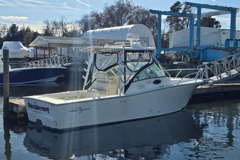 Slide: The Image of 2006 Albemarle 268 Express Fisherman boat docked at marina under clear sky. - 2