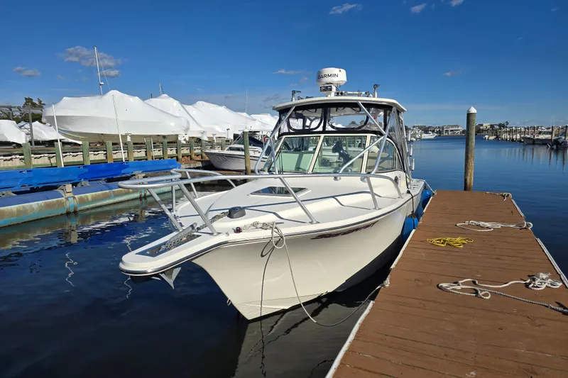 Slide: The Image of 2006 Albemarle 268 Express Fisherman boat docked at marina under clear blue sky. - 3