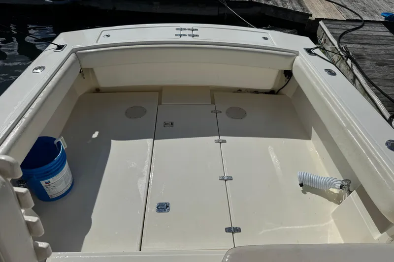 Slide: The Image of 2006 Albemarle 268 Express Fisherman boat deck with storage compartments and a blue bucket. - 5