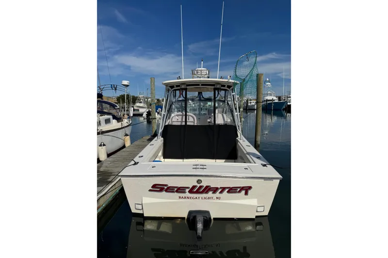 Slide: The Image of 2006 Albemarle 268 Express Fisherman boat docked at marina under clear blue sky. - 6