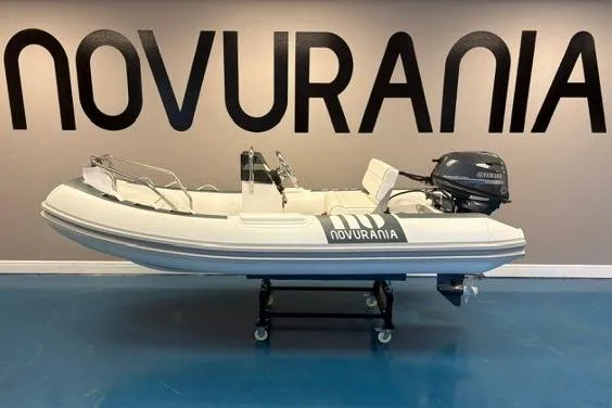 The Image of 2025 Novurania DL 335 boat with Yamaha 25 HP engine displayed indoors. - 0