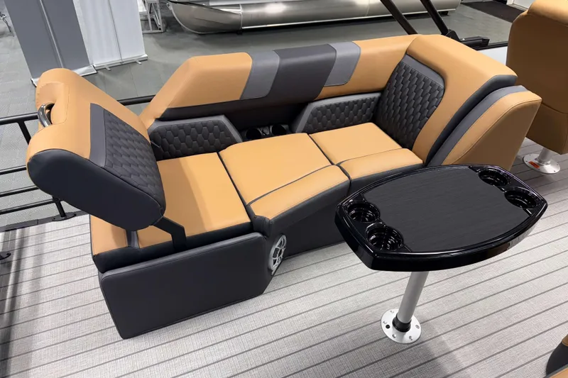 Slide: The Image of 2026 Sylvan L3 LZ boat interior with tan and gray seating, black table. - 16