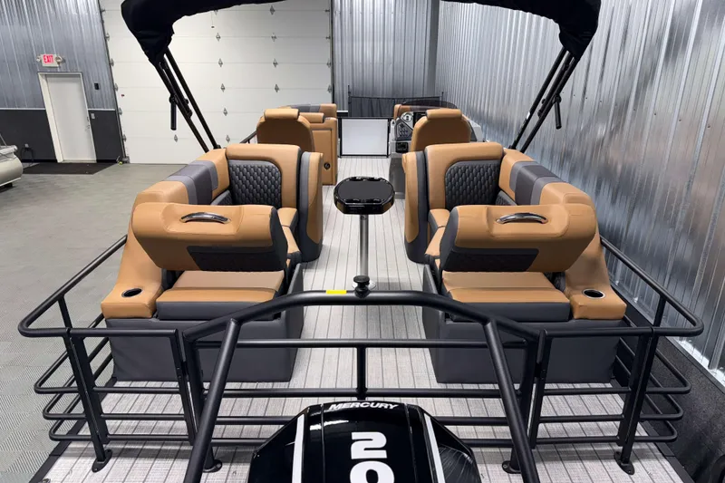 Slide: The Image of 2026 Sylvan L3 LZ pontoon boat with luxurious seating and modern design in a showroom. - 22