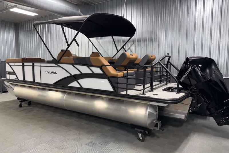 Slide: The Image of 2026 Sylvan L3 LZ pontoon boat with Mercury outboard motor in a showroom. - 29