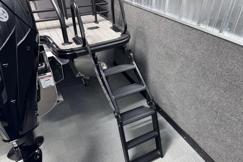 Slide: The Image of Ladder on 2026 Sylvan L3 LZ boat, black and silver design, indoor setting. - 30