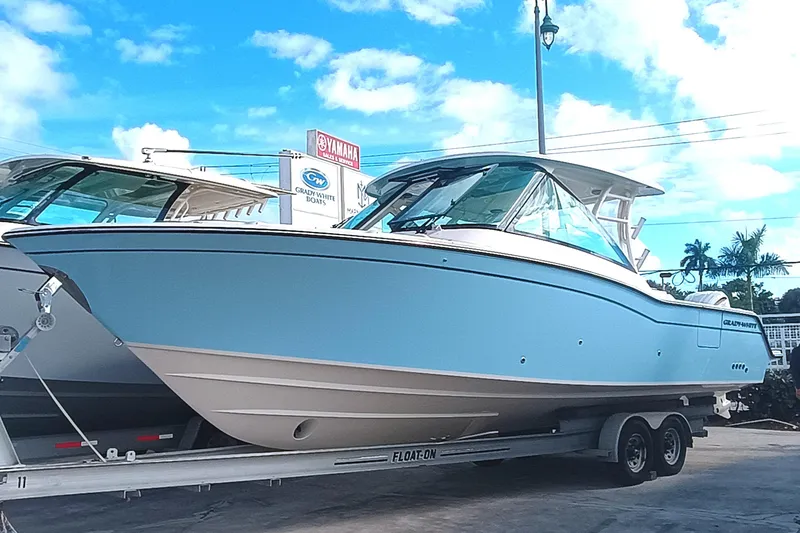 The Image of 2026 Grady-White Freedom 325 boat on trailer under blue sky. - 1