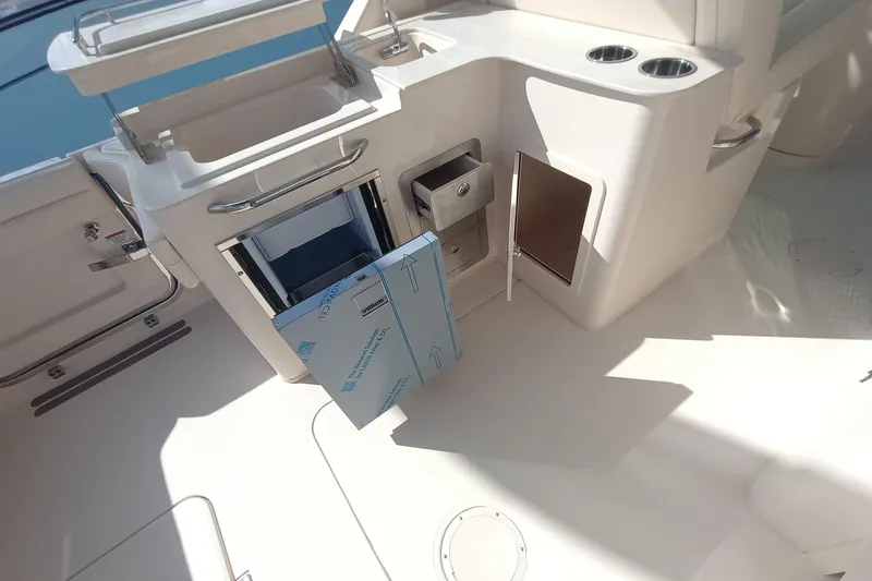 Slide: The Image of Interior of 2026 Grady-White Freedom 325 boat with storage compartments and cup holders. - 12