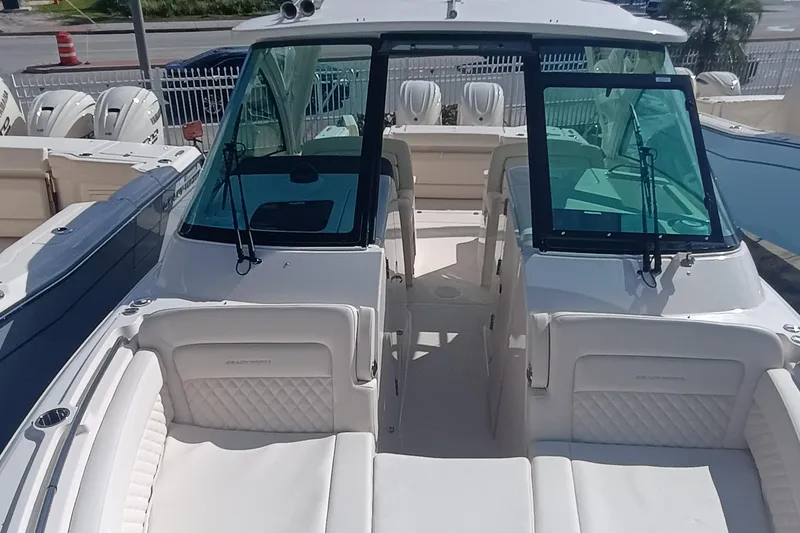 Slide: The Image of 2026 Grady-White Freedom 325 boat interior with white seating and windshield. - 24