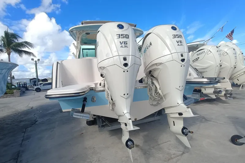 Slide: The Image of 2026 Grady-White Freedom 325 boat with twin Yamaha 350 V6 engines, docked under blue sky. - 29