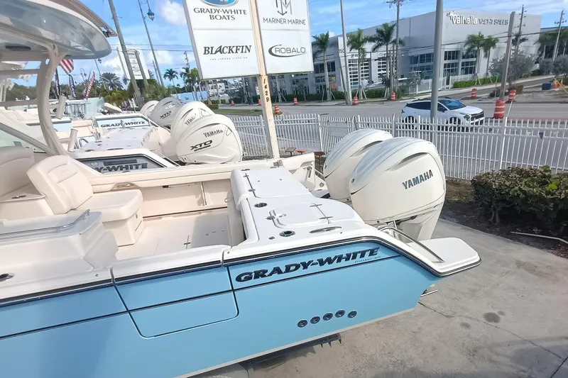 Slide: The Image of Grady-White Freedom 325 boat, 2026 model, on a trailer outdoors. - 31