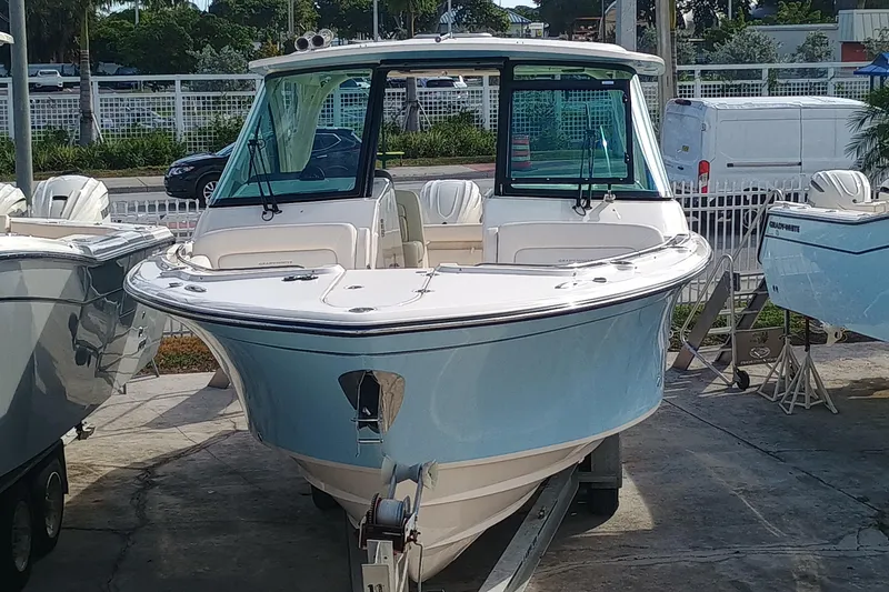 Slide: The Image of 2026 Grady-White Freedom 325 boat displayed outdoors on a trailer. - 5