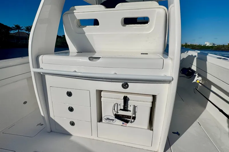 Slide: The Image of 2020 Intrepid 375 Nomad SE boat interior with storage compartments and cooler. - 19