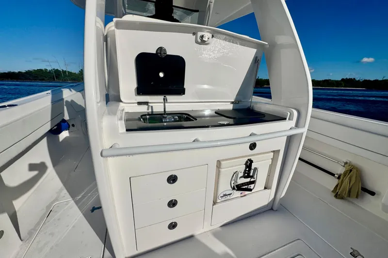 Slide: The Image of 2020 Intrepid 375 Nomad SE boat interior with sink and storage, ocean view. - 20
