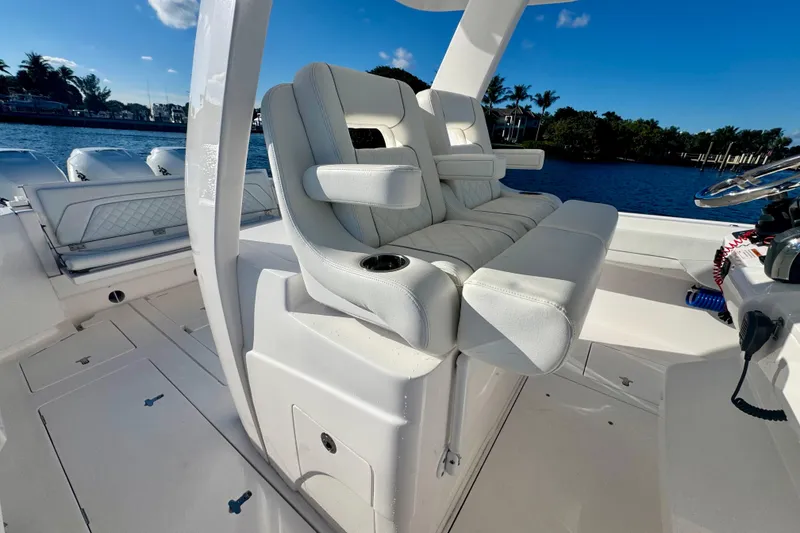 Slide: The Image of 2020 Intrepid 375 Nomad SE boat interior with luxurious seating and steering wheel. - 21