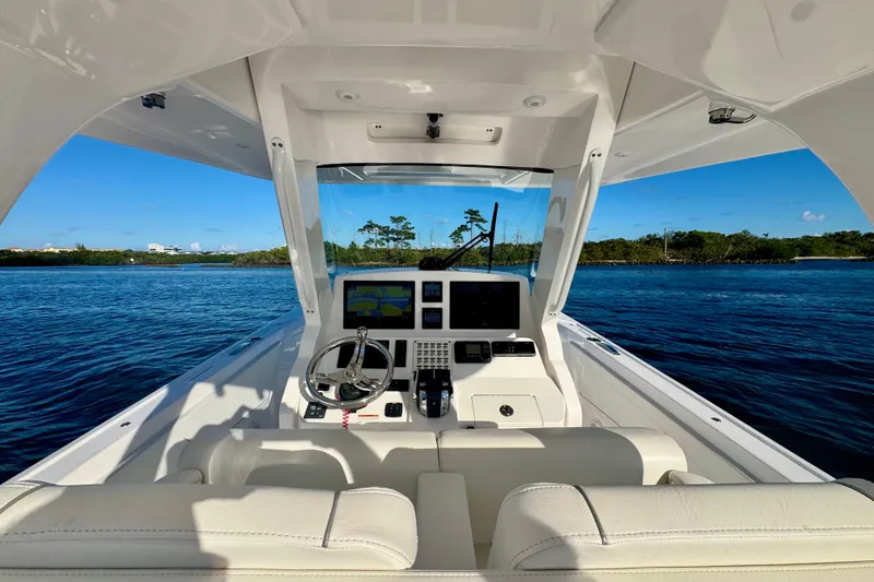 Slide: The Image of 2020 Intrepid 375 Nomad SE boat cockpit with modern navigation system on calm water. - 24