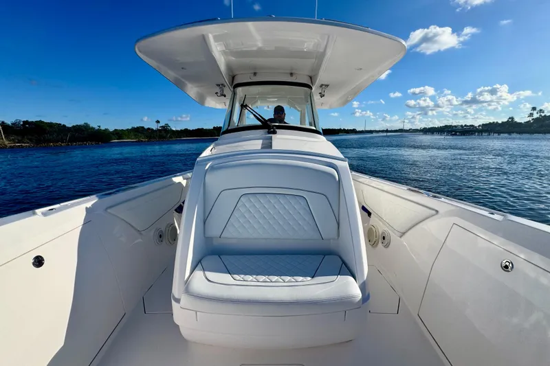 Slide: The Image of 2020 Intrepid 375 Nomad SE boat on calm water under clear blue sky. - 29