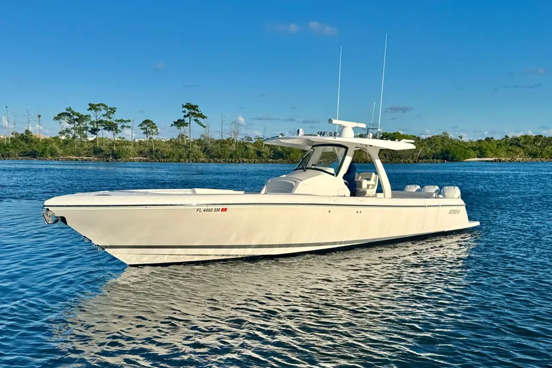 Slide: The Image of 2020 Intrepid 375 Nomad SE boat on calm water under clear blue sky. - 3