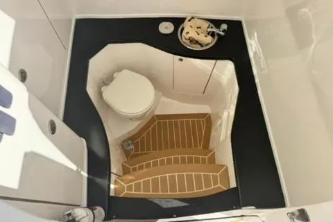 Slide: The Image of 2020 Intrepid 375 Nomad SE boat bathroom with toilet and wooden flooring. - 34