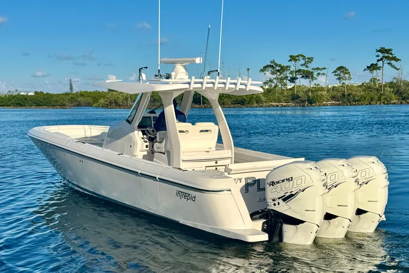 Slide: The Image of 2020 Intrepid 375 Nomad SE boat with triple Mercury Racing 400 engines on calm water. - 5