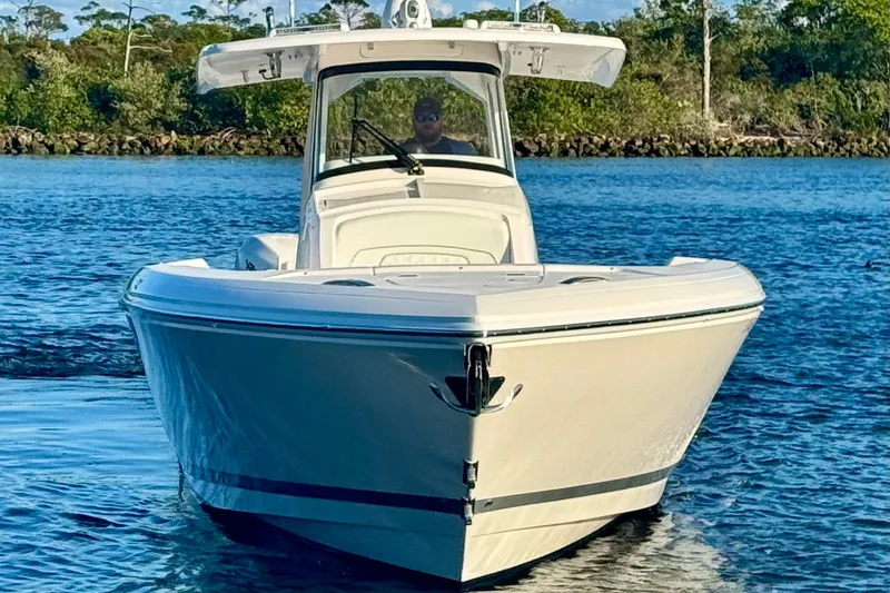 Slide: The Image of 2020 Intrepid 375 Nomad SE boat on calm water, front view. - 7