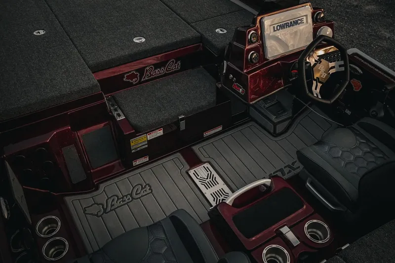 Slide: The Image of 2026 Bass Cat Lynx STS boat interior with steering wheel and Lowrance display. - 12