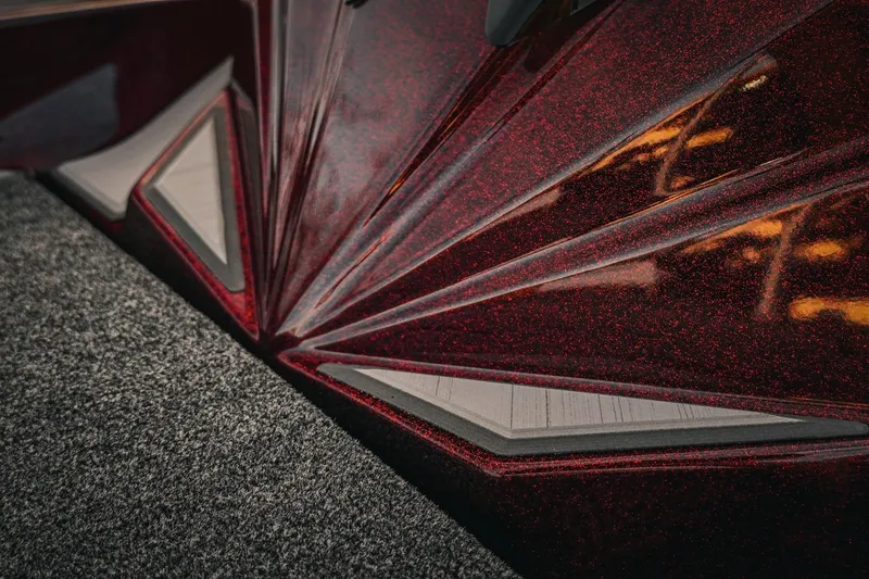 Slide: The Image of 2026 Bass Cat Lynx STS, detailed red metallic finish, close-up view. - 19