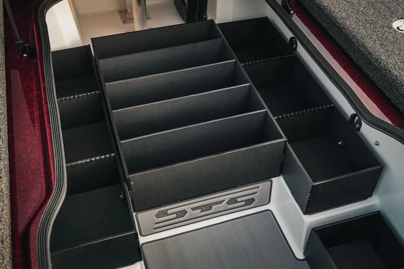 Slide: The Image of 2026 Bass Cat Lynx STS boat storage compartments with organized dividers. - 23