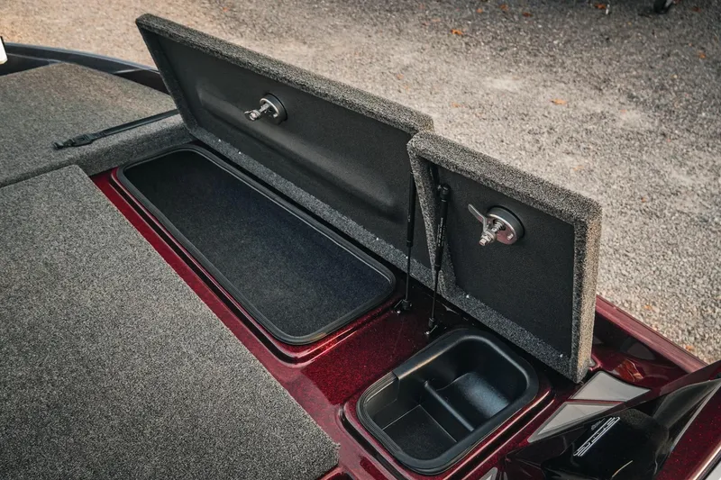 Slide: The Image of 2026 Bass Cat Lynx STS boat storage compartments with open lids, showcasing interior design. - 28