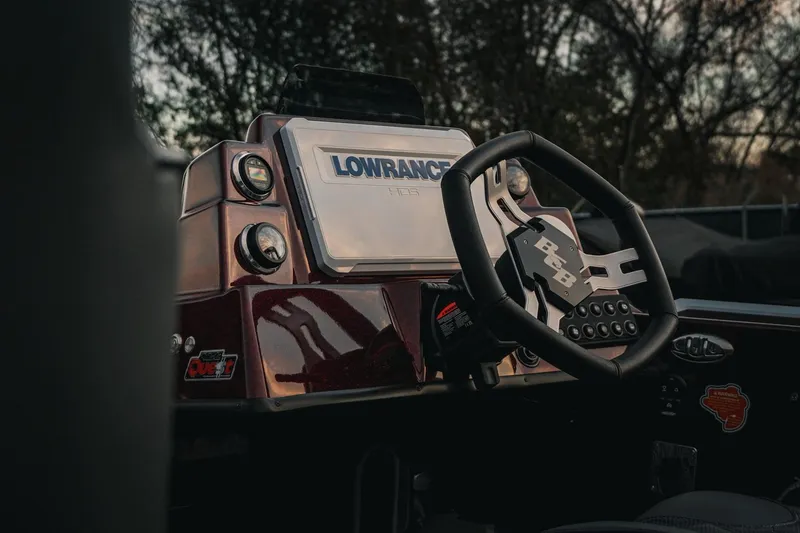 Slide: The Image of 2026 Bass Cat Lynx STS boat dashboard with Lowrance electronics and steering wheel. - 33