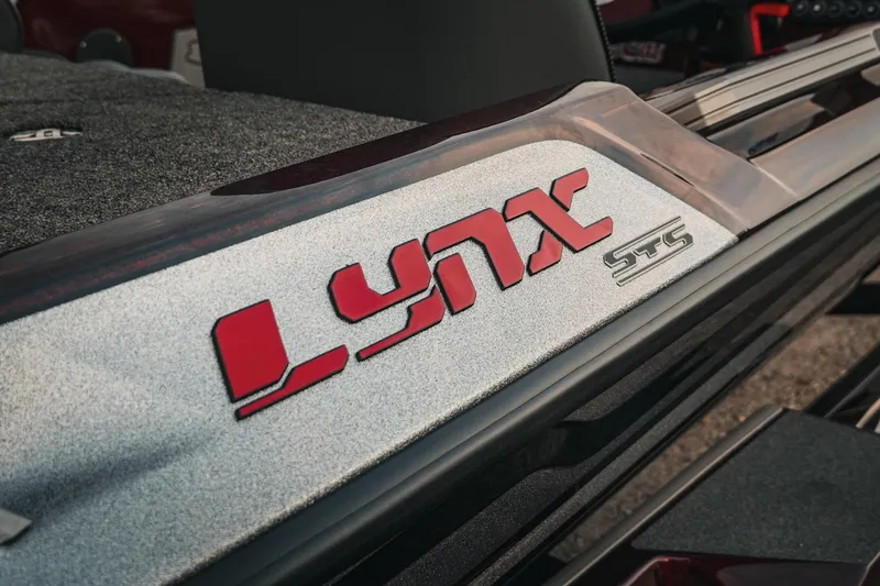 Slide: The Image of 2026 Bass Cat Lynx STS boat logo in red and silver. - 36