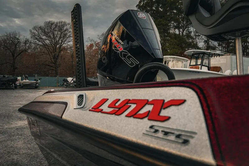 Slide: The Image of 2026 Bass Cat Lynx STS boat with Mercury Pro XS engine in outdoor setting. - 37