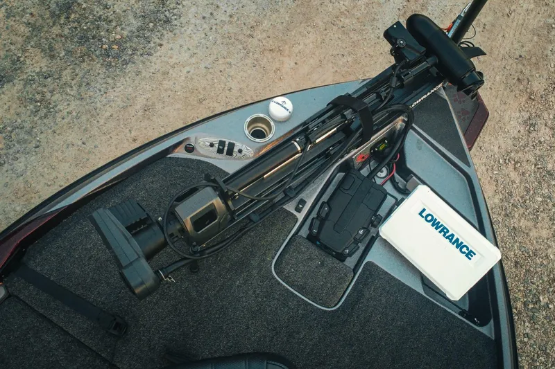 Slide: The Image of 2026 Bass Cat Lynx STS boat deck with Lowrance equipment and fishing gear. - 5