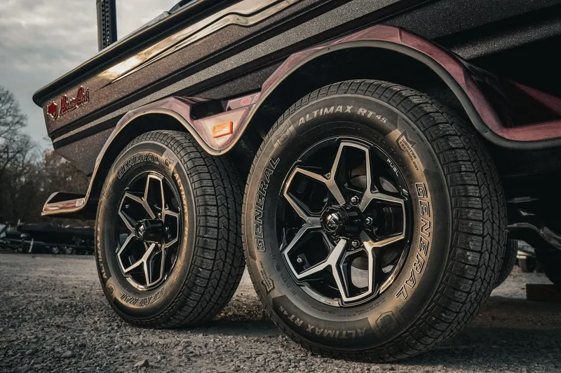 Slide: The Image of 2026 Bass Cat Lynx STS trailer with General Altimax RT45 tires on gravel. - 7