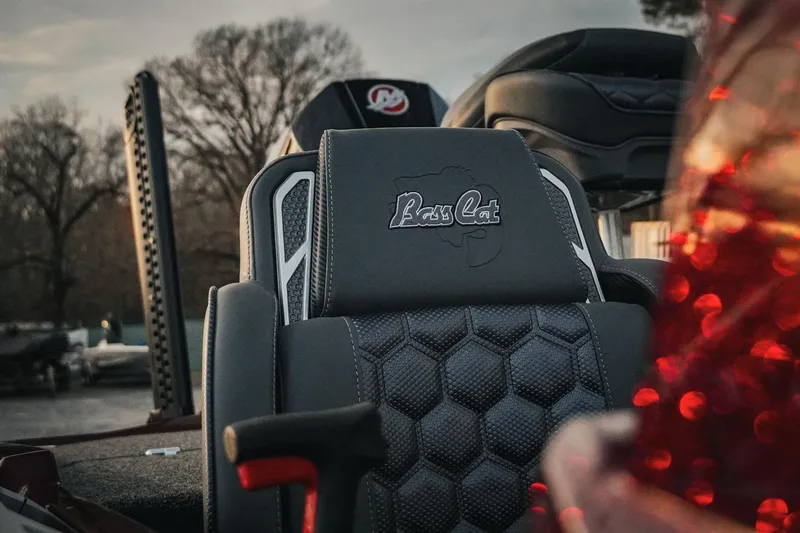 Slide: The Image of 2026 Bass Cat Lynx STS boat seat with logo, featuring hexagonal pattern design. - 8
