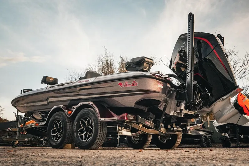 Slide: The Image of 2026 Bass Cat Lynx STS boat on trailer, showcasing sleek design and powerful engine. - 9