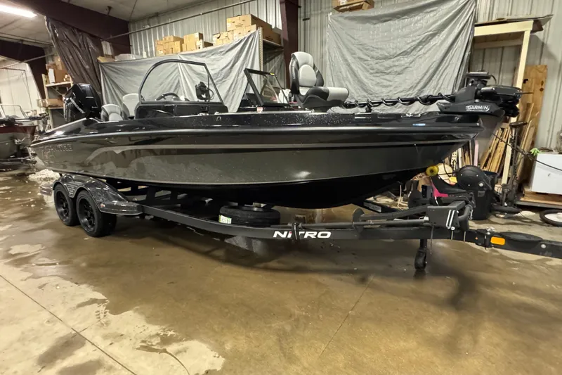 Slide: The Image of 2026 Nitro ZV21 Pro boat on trailer in a warehouse setting. - 2