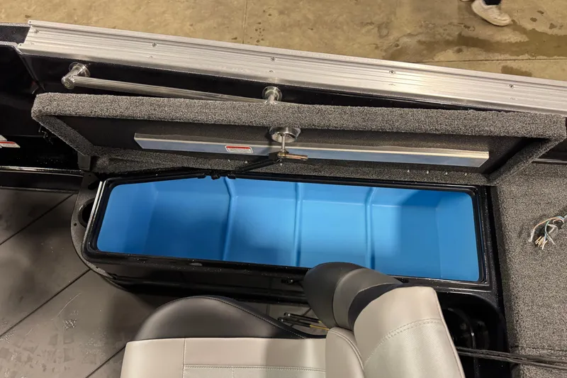 Slide: The Image of Open storage compartment in 2026 Nitro ZV21 Pro boat, featuring blue interior and gray seating. - 22
