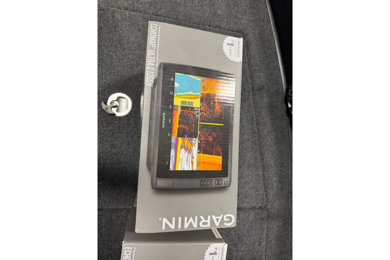 Slide: The Image of Boxed Garmin ECHOMAP Ultra 126SV on gray carpet, featuring vibrant display. - 25