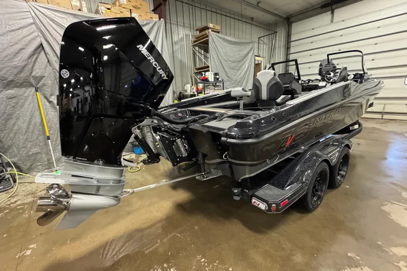 Slide: The Image of 2026 Nitro ZV21 Pro boat with Mercury engine in a garage setting. - 3