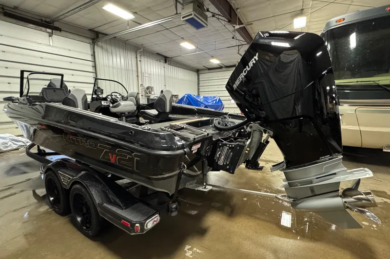 Slide: The Image of 2026 Nitro ZV21 Pro boat with Mercury engine in a garage setting. - 4