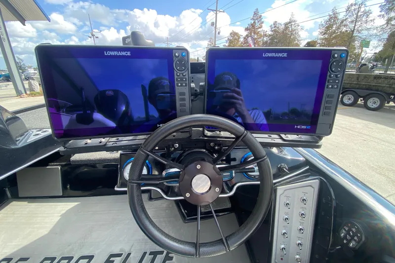Slide: The Image of 2023 Blazer 625 Pro Elite boat dashboard with dual Lowrance displays and steering wheel. - 18