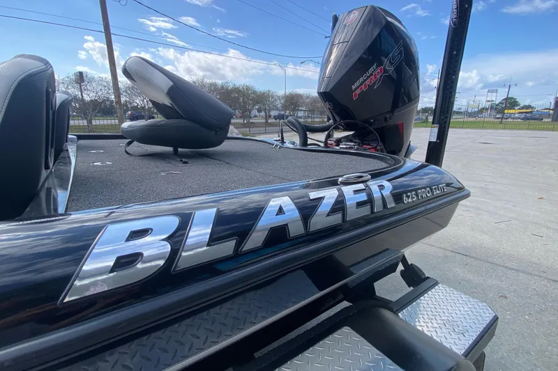 Slide: The Image of 2023 Blazer 625 Pro Elite boat with Mercury Pro XS engine, parked outdoors. - 24