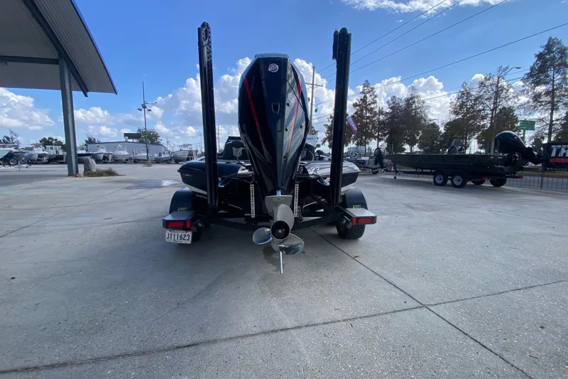 Slide: The Image of 2023 Blazer 625 Pro Elite boat on trailer, rear view, outdoor dealership setting. - 4