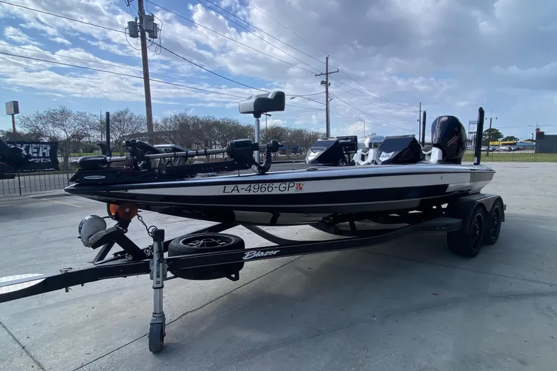 Slide: The Image of 2023 Blazer 625 Pro Elite boat on trailer, parked outdoors under cloudy sky. - 8
