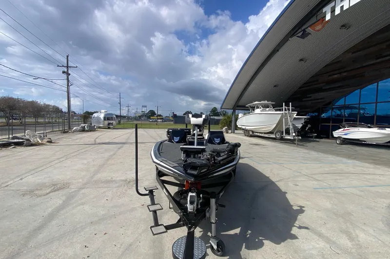 Slide: The Image of 2023 Blazer 625 Pro Elite boat displayed outside a showroom under a cloudy sky. - 9