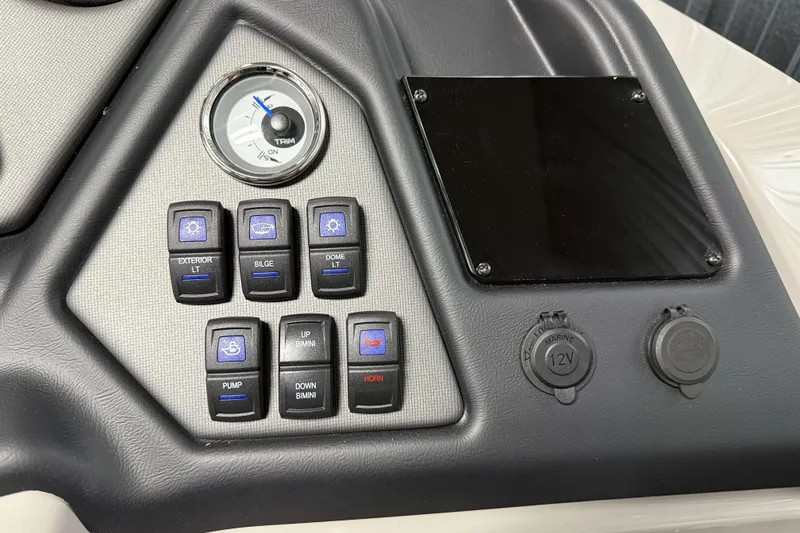 Slide: The Image of Control panel of 2026 Sylvan L3 SLZ boat with switches and trim gauge. - 13