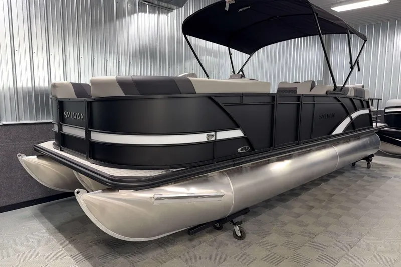 Slide: The Image of 2026 Sylvan L3 SLZ pontoon boat in showroom with sleek black design. - 24
