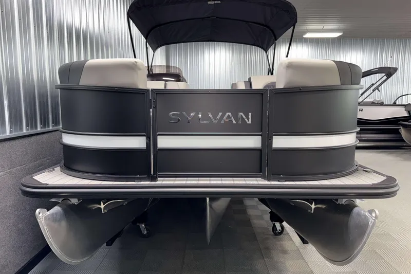 Slide: The Image of 2026 Sylvan L3 SLZ pontoon boat in showroom, sleek black design. - 25
